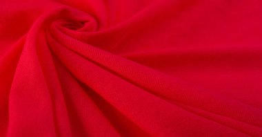 Kırmızı bez. Lüks kumaşın soyut arka planı ya da dalgaların sıvı ipek dokusu ya da dalgalı kıvrımlar. arka plan ya da zarif duvar kağıdı tasarımı. Pamuk dokusu, doğal kumaş ve boya, parlak kırmızı renk..