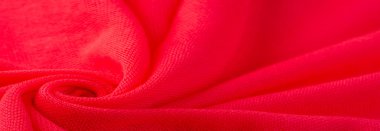 Kırmızı bez. Lüks kumaşın soyut arka planı ya da dalgaların sıvı ipek dokusu ya da dalgalı kıvrımlar. arka plan ya da zarif duvar kağıdı tasarımı. Pamuk dokusu, doğal kumaş ve boya, parlak kırmızı renk..