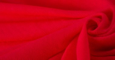 Kırmızı bez. Lüks kumaşın soyut arka planı ya da dalgaların sıvı ipek dokusu ya da dalgalı kıvrımlar. arka plan ya da zarif duvar kağıdı tasarımı. Pamuk dokusu, doğal kumaş ve boya, parlak kırmızı renk..