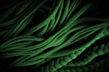 Doku, arka plan, desen. Yeşil örgülü kumaş. Kabartmalı desenli örgü bir arka plan. Örgü ören örgüler..