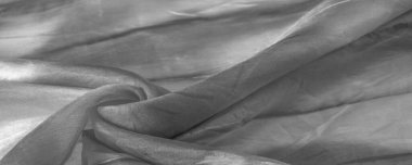 Beyaz arka planda gri benekli siyah beyaz kumaş. Soyut tasarımcı kumaş tasarımcısı. Tasarımın için güzel bir arka plan. Doku. Görüntü. çizim, kalıp, şekil