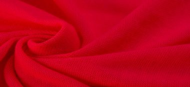 Kırmızı bez. Lüks kumaşın soyut arka planı ya da dalgaların sıvı ipek dokusu ya da dalgalı kıvrımlar. arka plan ya da zarif duvar kağıdı tasarımı. Pamuk dokusu, doğal kumaş ve boya, parlak kırmızı renk..
