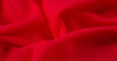 Kırmızı bez. Lüks kumaşın soyut arka planı ya da dalgaların sıvı ipek dokusu ya da dalgalı kıvrımlar. arka plan ya da zarif duvar kağıdı tasarımı. Pamuk dokusu, doğal kumaş ve boya, parlak kırmızı renk..