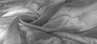 Beyaz arka planda gri benekli siyah beyaz kumaş. Soyut tasarımcı kumaş tasarımcısı. Tasarımın için güzel bir arka plan. Doku. Görüntü. çizim, kalıp, şekil