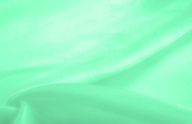 Yeşil soluk ipek kumaş, pürüzsüz kırmızı ipek ya da lüks saten kumaş, düğün arka planı olarak doku. Lüks arka plan tasarımı. Retro biçimi.