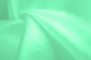 Yeşil soluk ipek kumaş, pürüzsüz kırmızı ipek ya da lüks saten kumaş, düğün arka planı olarak doku. Lüks arka plan tasarımı. Retro biçimi.