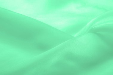 Yeşil soluk ipek kumaş, pürüzsüz kırmızı ipek ya da lüks saten kumaş, düğün arka planı olarak doku. Lüks arka plan tasarımı. Retro biçimi.