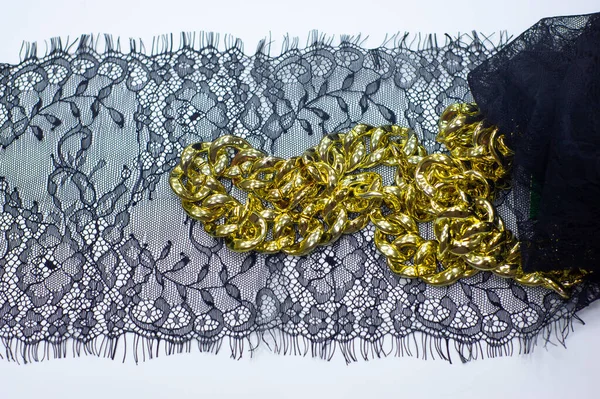 Black lace on a white background. black lace trim around the yard. fabric for underwear. crochet trim. your design. postcard invitation. texture background pattern. golden chain