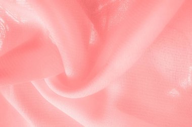 Doku. Geçmişi. kırmızı pembe ipek kumaş. İnce, güçlü, yumuşak, parlak bir lif ipek böcekleri tarafından kozalar oluşturuluyor ve iplik ve kumaş yapmak için toplanıyor..