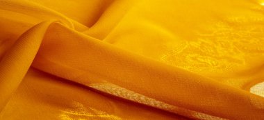 Doku. Geçmişi. Şablon. Bir yüzeyin ya da maddenin hissi, görünüşü ya da tutarlılığı. Sarı ipek kumaş