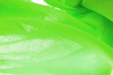 Yeşil ipek doku, yeşil ince tahıl kumaşı. Masaüstü ürünü, görüntü perspektifi, stüdyo fotoğrafçılığı. ürün demo afişi.