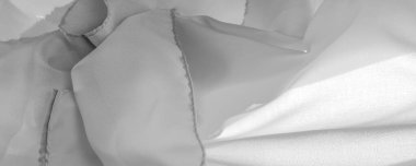 Tek renkli ipek kumaş, zarif, dalgalı, siyah beyaz saten ipek kumaş, soyut tasarım. arkaplan dokusu, desen