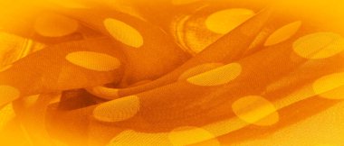 Puantiyeli sarı ipek kumaş, kumaşın üzerindeki dairesel noktalar ya da daireye benziyor. Arkaplan dokusu, dekoratif süs