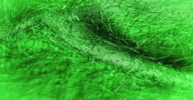 Arkaplan dokusu, dekoratif süs, yeşil ipek kumaş, kumaşta dokuma iplikleri, kabarık efekt, his, görünüş veya yüzey dokusu