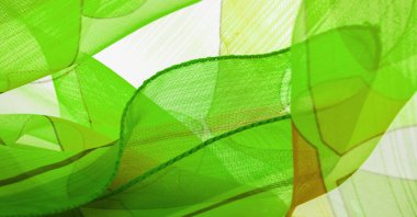 ince örülmüş kumaş - açık şeffaf, yeşil, beyaz ve sarı geometrik renkler, ince ipek ipekten bir peçe gibi. Organza deseni. Doku. Arkaplan