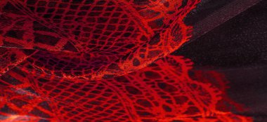 Tekstil malzemesinden kırmızı arka plan. dantel kumaş. Doğal yakut dokusu. Doku, arkaplan, desen.