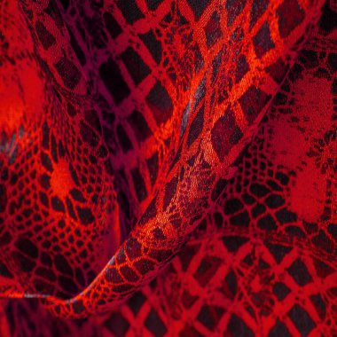 Tekstil malzemesinden kırmızı arka plan. dantel kumaş. Doğal yakut dokusu. Doku, arkaplan, desen.