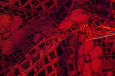 Tekstil malzemesinden kırmızı arka plan. dantel kumaş. Doğal yakut dokusu. Doku, arkaplan, desen.