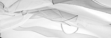 ince örülmüş kumaş - açık şeffaf, siyah ve beyaz, tek renkli geometrik renkler, ince yapışkan ipekten yapılmış bir peçe gibi. organza deseni.