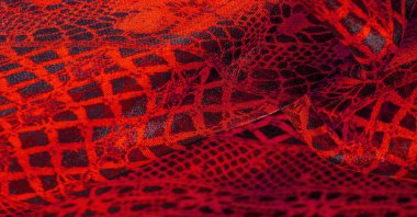 Tekstil malzemesinden kırmızı arka plan. dantel kumaş. Doğal yakut dokusu. Doku, arkaplan, desen.