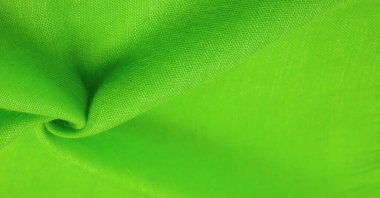 Yeşil ipek doku, yeşil ince tahıl kumaşı. Masaüstü ürünü, görüntü perspektifi, stüdyo fotoğrafçılığı. ürün demo afişi.