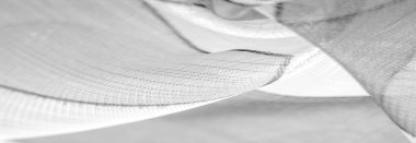ince örülmüş kumaş - açık şeffaf, siyah ve beyaz, tek renkli geometrik renkler, ince yapışkan ipekten yapılmış bir peçe gibi. organza deseni.