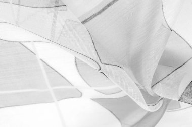 ince örülmüş kumaş - açık şeffaf, siyah ve beyaz, tek renkli geometrik renkler, ince yapışkan ipekten yapılmış bir peçe gibi. organza deseni.