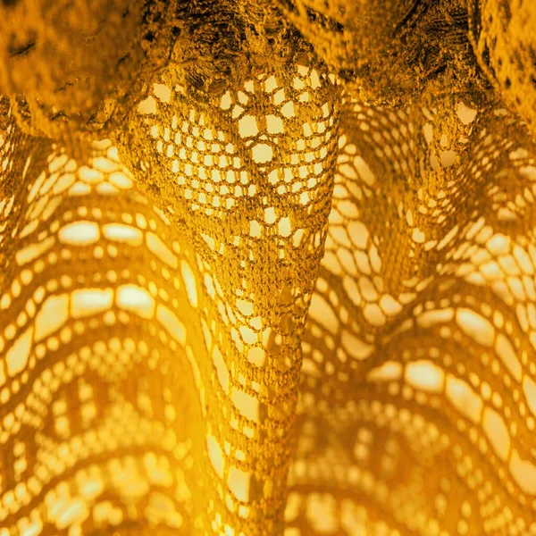 Background, texture, pattern, yellow lace fabric, thin open fabric, usually made of cotton or silk, made using loops, twisting or knitting threads in patterns