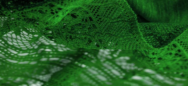 Background, texture, pattern, green lace fabric, thin open fabric, usually made of cotton or silk, made using loops, twisting or knitting threads in patterns