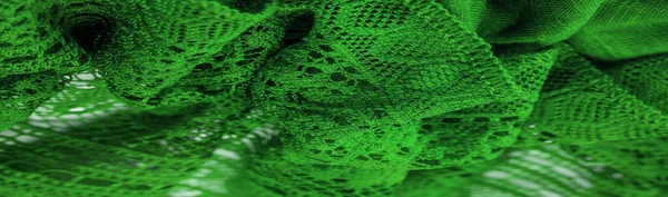 Background, texture, pattern, green lace fabric, thin open fabric, usually made of cotton or silk, made using loops, twisting or knitting threads in patterns