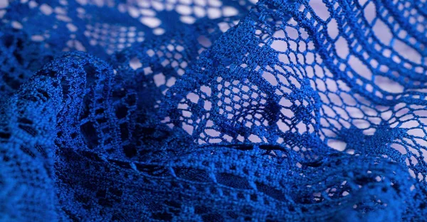 Background, texture, pattern, blue lace fabric, thin open fabric, usually made of cotton or silk, made using loops, twisting or knitting threads in patterns