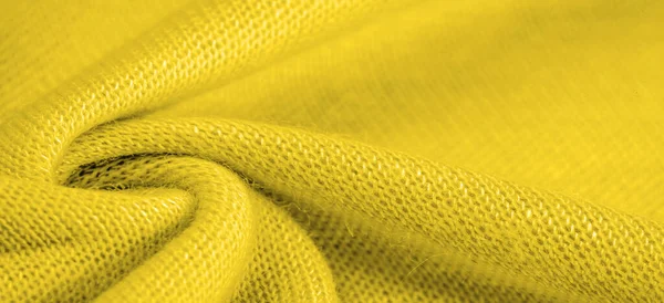 Yellow woolen fabric. Amber yellow felt texture, abstract art. Background texture, pattern