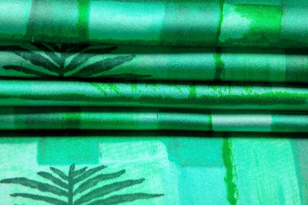 Texture. Background. Template. green lettuce gray silk fabric with an abstract pattern, a print of flora twigs. verdant, lawny, virid, vealy