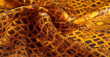 Tekstil malzemesinden kahverengi arka plan. dantel kumaş. Doğal kehribar dokusu. Doku, arkaplan, desen.