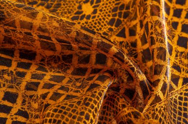 Tekstil malzemesinden kahverengi arka plan. dantel kumaş. Doğal kehribar dokusu. Doku, arkaplan, desen.