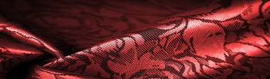 Çiçek desenli kırmızı ipek kumaş, güzel görünüş, eşsiz parlaklık kabartmalı desen, bileşik tekstil. rahatlama deseni