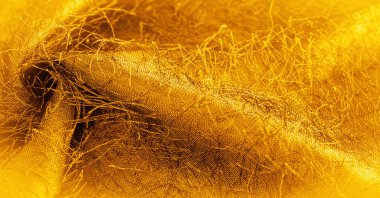 Kahverengi sarı ipek kumaş, kumaşta dokuma iplikleri, kabarık efekt. Arkaplan dokusu, dekoratif süs