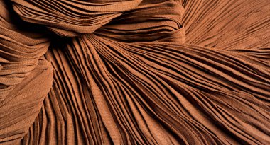 Doku, arkaplan, desen, kumaş kahverengi. Kayısı rengi. Gofre ve pileli. Tasarım projeleri lüks ve modaya uygun hale getiriyor. Bu kumaş köşeler, DIY projeleri vs. kullanılabilir.