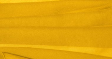 Sarı ipek kumaş. Hoş bir parlaklığı olan çok hafif yapışkan kumaş. Çevrimiçi projelerine zarafet katmak için mükemmel. doku arkaplanı, desen