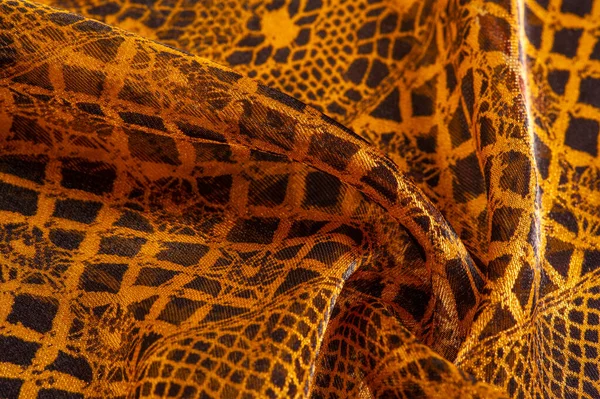 Tekstil malzemesinden kahverengi arka plan. dantel kumaş. Doğal kehribar dokusu. Doku, arkaplan, desen.