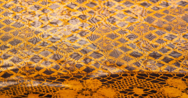 коричневый фон из текстильного материала. кружевной ткани. Естественная текстура янтаря. Текстура, фон, шаблон.