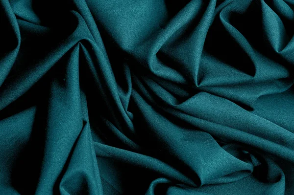 Textured, background, pattern, turquoise fabric. This is an unusual fabric that has an elegant appearance with a rich and coarse texture. It is tightly knit with designs built into the fabric itself