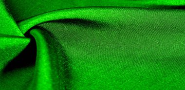 Yeşil kumaş. Doğal kumaştan soyut kırmızı arkaplan. Pamuk. Doku, arkaplan, desen