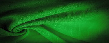 Yeşil kumaş, derin zümrüt ipeği, koyu yeşil dokuma kumaş dokusu arka plan. Dekoratif eşyalar yakın plan. Duvar kağıdı dokusu, arkaplan