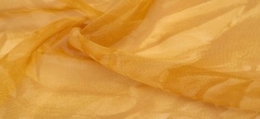 Sarı ipek kumaş, soyut kehribar ipek arka plan. Kumaşlı kumaş. Uzayı kopyala Tasarım elemanı. Sevgililer Günü. Doku deseni, süs, arkaplan