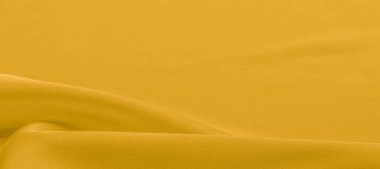 Sarı ipek kumaş. Çok hafif, yumuşak kumaşlı, bol kumaşlı ve ince bir mat parıltısıyla pürüzsüz bir dokusu var. arkaplan dokusu, desen.