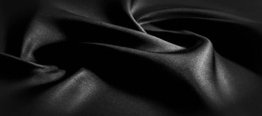 Siyah ipek kumaş. Panoramik fotoğraf. Atlas güzel ve asil bir ipek kumaştır. Işıldayan bir parıltısı, dokusu, arkaplanı, deseni var..