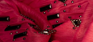 İpek desenli, kırmızı kumaş ve dekoratif yüzlü taşlar. parlak renkli taşlarla dokuma arkaplanı, doku arkaplan tasarımı