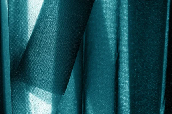 Textured, background, pattern, turquoise fabric. This is an unusual fabric that has an elegant appearance with a rich and coarse texture. It is tightly knit with designs built into the fabric itself