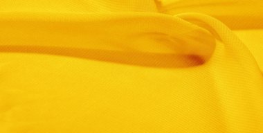 Sarı ipek kumaş. Bu ipek organzanın yumuşak bir açık dokuması var. Özel durumlar için tasarladığınız her şey için bu lüks kumaşı kullanın.